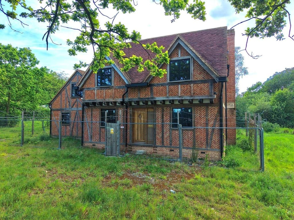 TUDOR-STYLE HOUSE IN NEED OF COMPLETION OCCUPYING OVER TWO ACRES — photo 1